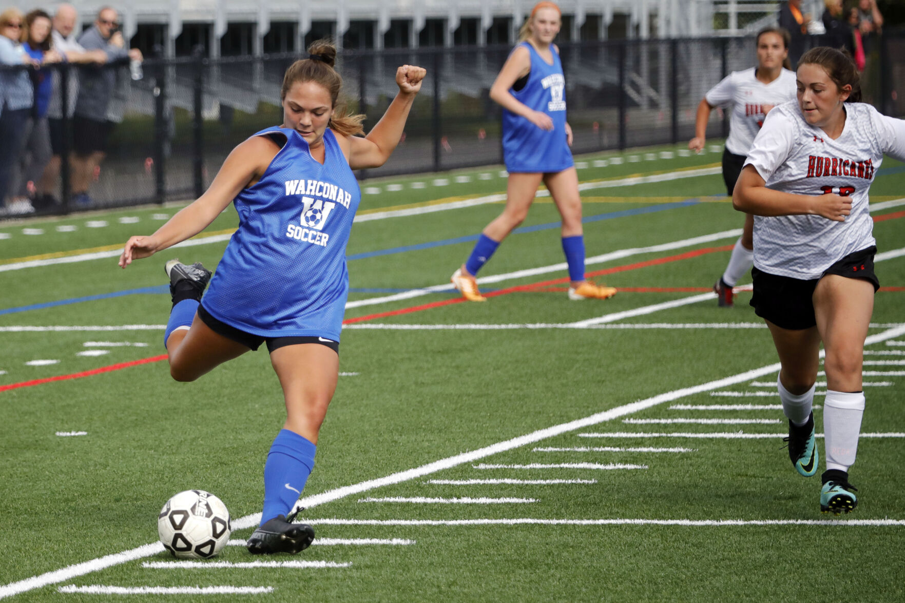 high school girls play soccer